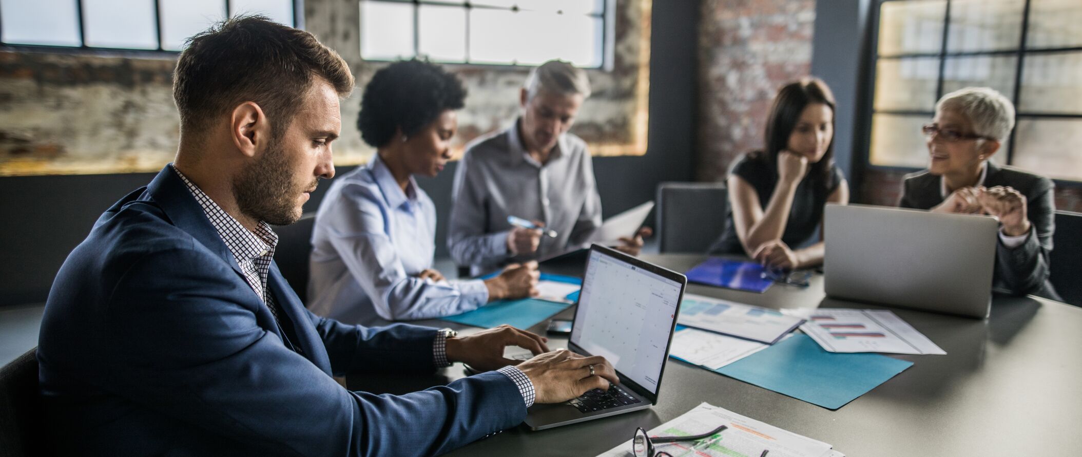 Banner-corp-businessman-using-laptop-on-a-meeting.jpg