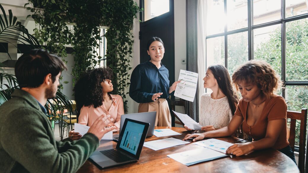 Multiracial group discussing business