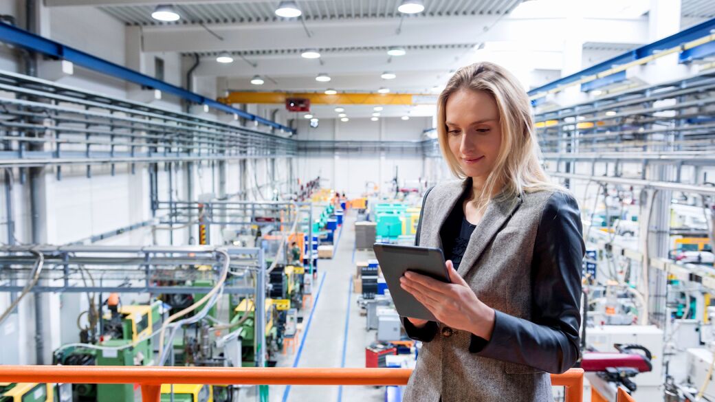 Female manager looking a tablet at factory