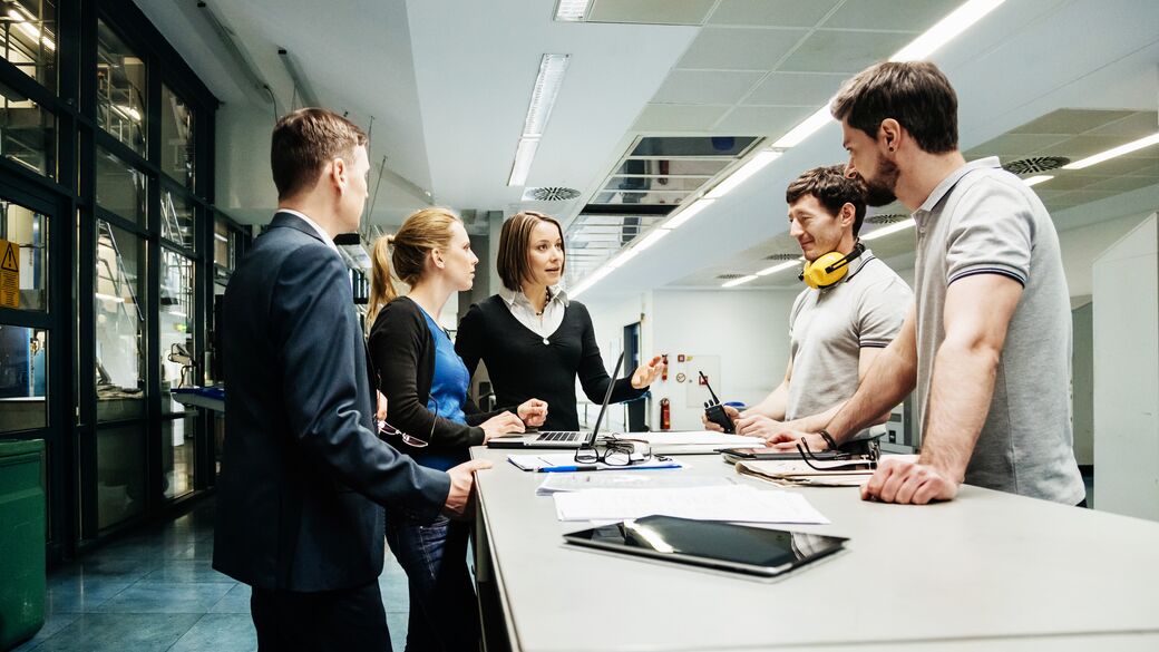 mfg-team-of-engineers-holding-meeting-in-factory.jpg